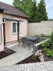 a patio with a table and chairs in front of a house at Ubytování v soukromí Anička in Lednice