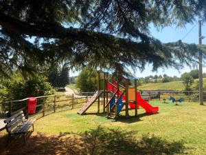 a park with a playground with a slide and a bench at Hotel Monte Baldo in Brenzone sul Garda