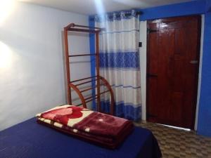 a bedroom with a bed with a ladder and a door at RK Guest in Nanu Oya