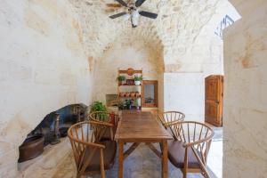 a dining room with a wooden table and chairs at Old Town Urfa in Urfa