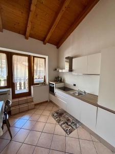 a kitchen with a sink and a counter top at Pragma Apartments - Casa Defrancesco in Cavalese