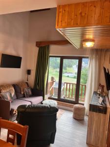 a living room with a couch and a large window at ABELLETES - K31 DeuSol - Vall d'Incles - Soldeu Hut 6057 in Incles