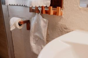 a white dress is hanging on a rack in a bathroom at Casa Camino in Rubiana