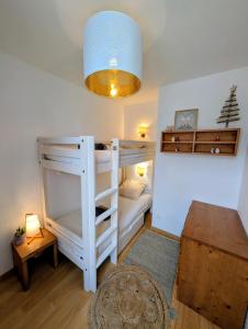 a room with a bunk bed and a table at Cocon Luchon in Luchon
