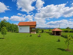 a large field with a house and a pavilion at GREEN MOON Breza in Breza