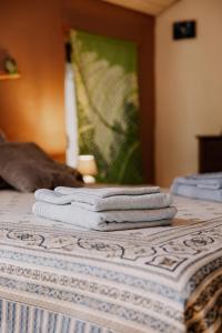 three towels sitting on top of a table at Casa Camino in Rubiana