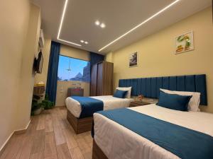 a hotel room with two beds and a window at Royal Night Pyramids View Inn in Cairo