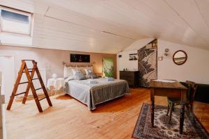 a bedroom with a bed and a ladder and a desk at Casa Camino in Rubiana
