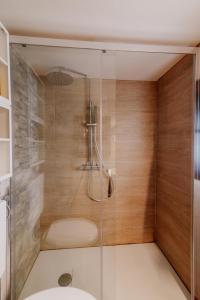 a shower with a glass door in a bathroom at Casa Camino in Rubiana +29 photos