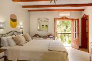 a bedroom with a bed and a sliding glass door at Finca rural Los Tanquillos in San Bartolomé +37 photos