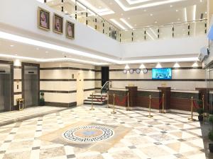 a lobby with a staircase in a building at Zaha Al Madina Hotel in Medina