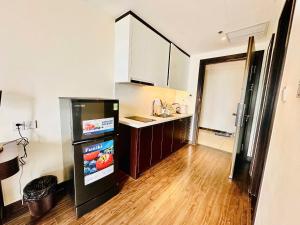 a small kitchen with a counter and a refrigerator at Sapphire Premium Studio Hạ Long in Ha Long
