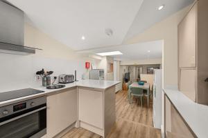 a kitchen with white counters and a dining room at 114 North Street in St. Andrews