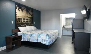 a hotel room with a bed and a sink at Studio 6 Suites Opelousas, LA in Opelousas