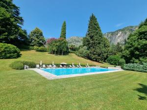 a swimming pool in the middle of a grass field at Princess Night con piscina in Griante Cadenabbia