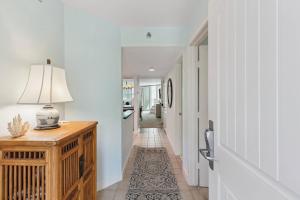 a hallway with a table with a lamp on it at North Breakers 201 in Saint Simons Island