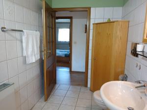 a bathroom with a sink and a toilet at FeWo Waldblick in Salzhemmendorf +34 photos