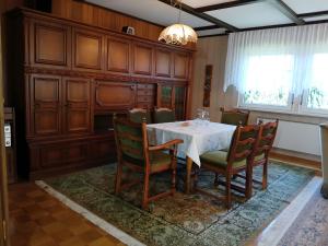 a dining room with a white table and chairs at FeWo Waldblick in Salzhemmendorf