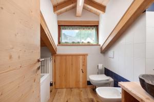 a bathroom with a toilet and a sink at Maso Rubino in Rabbi +34 photos