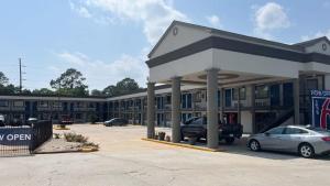 a gas station with a car parked in a parking lot at Studio 6 Suites Opelousas, LA in Opelousas