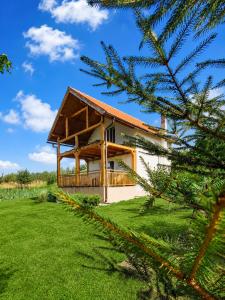 a house with a green yard and a tree at GREEN MOON Breza in Breza +16 photos