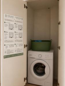 a washing machine with a green basket on top of it at Borgo&Lago Home in Castro