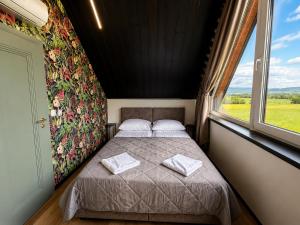a bed in a room with a window at D'Pazur- sauna, jacuzzi in Białka Tatrzańska