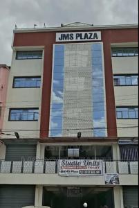 a building with a sign that reads jms plays plaza at Gweth Haven Homes in Nakuru