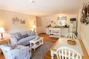 a living room with a couch and a table at Private Association Pool Great Location in Wellfleet +20 photos
