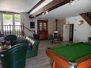 a living room with a pool table at Auberge de la Belette in Le Monestier