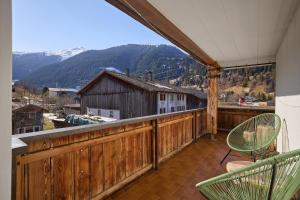 a balcony with chairs and a view of a mountain at Landhaus Angelika in Gaschurn