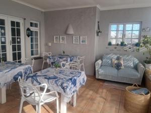 a living room with two tables and a couch at Franmarel in Plettenberg Bay