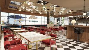 a restaurant with tables and chairs and a checkered floor at Holiday Inn & Suites Tijuana Downtown by IHG in Tijuana +13 photos