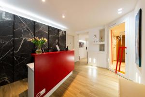 a hallway with a red and black wall at Municipio Luxury Suite in Naples