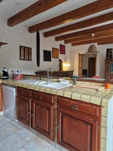 a kitchen with a sink and a dishwasher at Chez raymonde in Teyran