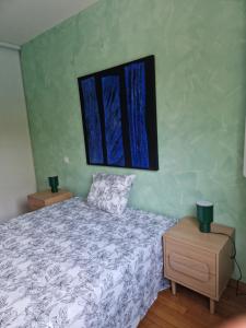 a bedroom with a bed and a painting on the wall at Chez raymonde in Teyran