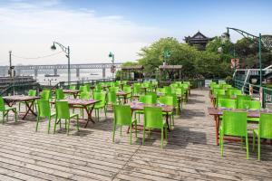 a row of tables and chairs on a boardwalk at Holiday Inn Wuhan Riverside by IHG in Wuhan