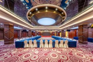 a conference room with a blue table and chairs at Holiday Inn Wuhan Riverside by IHG in Wuhan