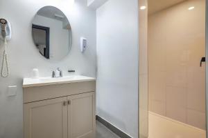 a bathroom with a sink and a shower at Motel Newstar Laval in Laval +17 photos