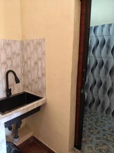 a bathroom with a sink and a shower at Penginapan Griya Safira in Taliwang