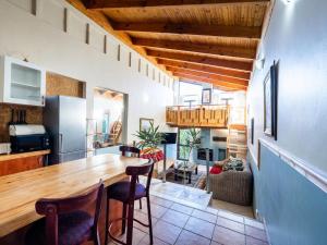 a kitchen and living room with a table and chairs at Aurora Guest Units in Durbanville