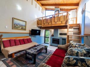 a living room with a loft bed and a couch at Aurora Guest Units in Durbanville