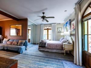 a bedroom with a bed and a couch at Aurora Guest Units in Durbanville