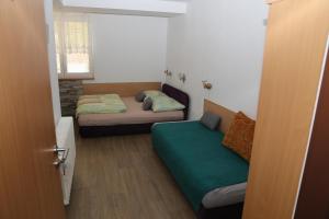a small room with two beds and a window at Penzion Chřiby in Staré Hutě +13 photos