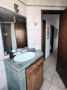 a bathroom with a sink and a mirror at Apartamento playero Privado WiFi- MorroJable in Morro del Jable +34 photos