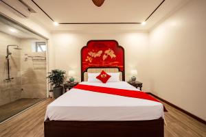 a bedroom with a large bed and a shower at Lake Hotel Sóc Sơn in Sóc Sơn