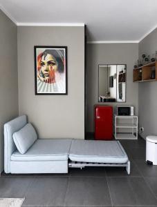 a room with a bed and a red refrigerator at Chambre style hôtel in Sablet