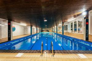 a large swimming pool in a building at Drimsynie Estate Hotel in Lochgoilhead