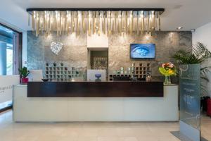 a restaurant lobby with a reception desk and chandelier at Smy Bologna Centrale in Bologna