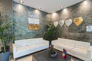 a living room with a white couch and hearts on the wall at Smy Bologna Centrale in Bologna